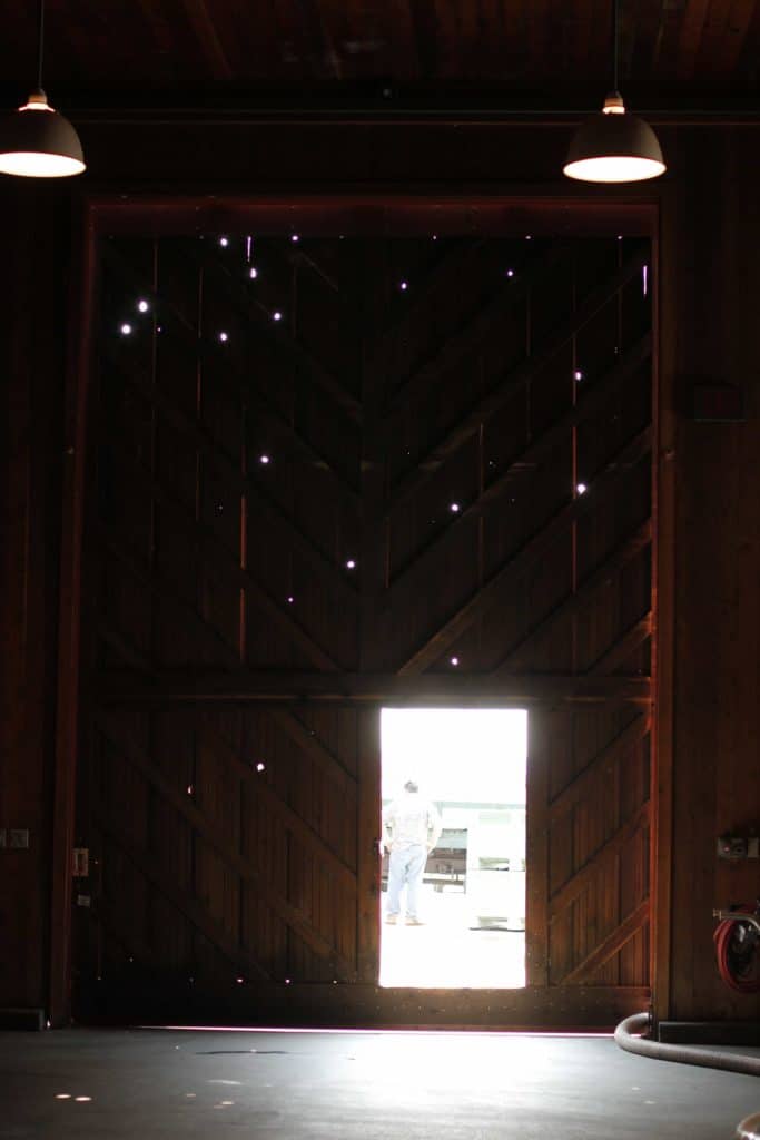 interior of a barn with an open door to the outside