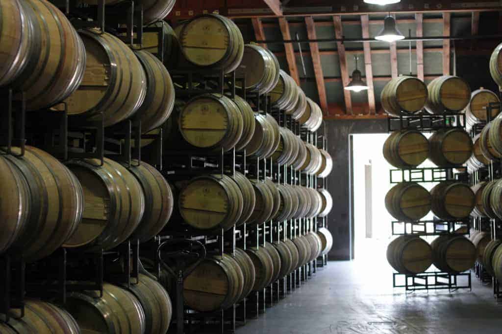 wine barrels stored on metal racks
