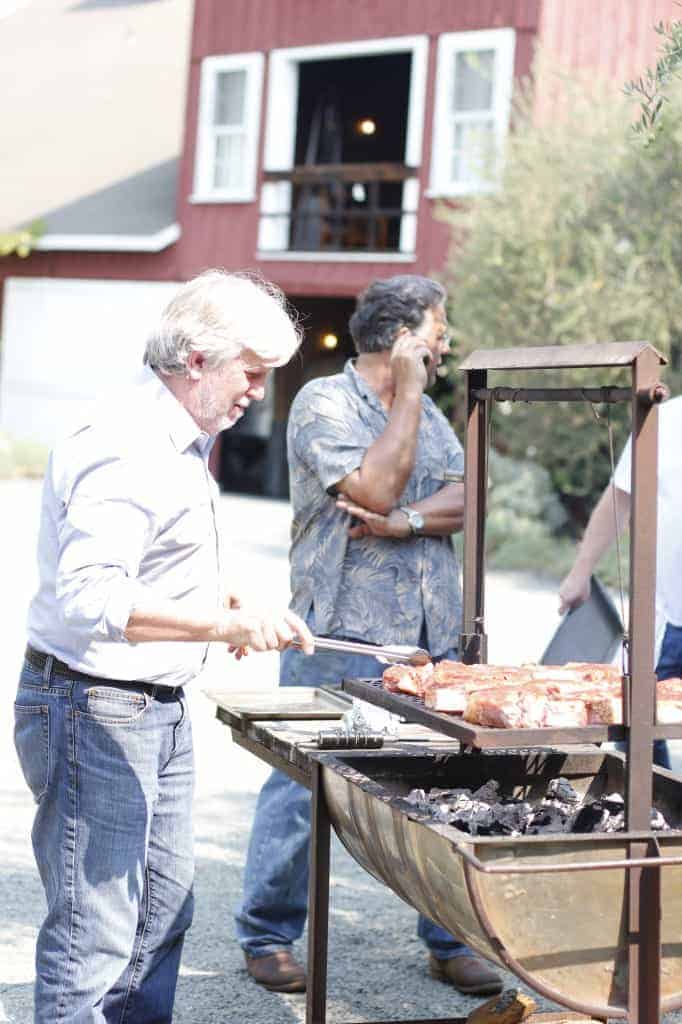a man grills steak outside in Napa Valley California