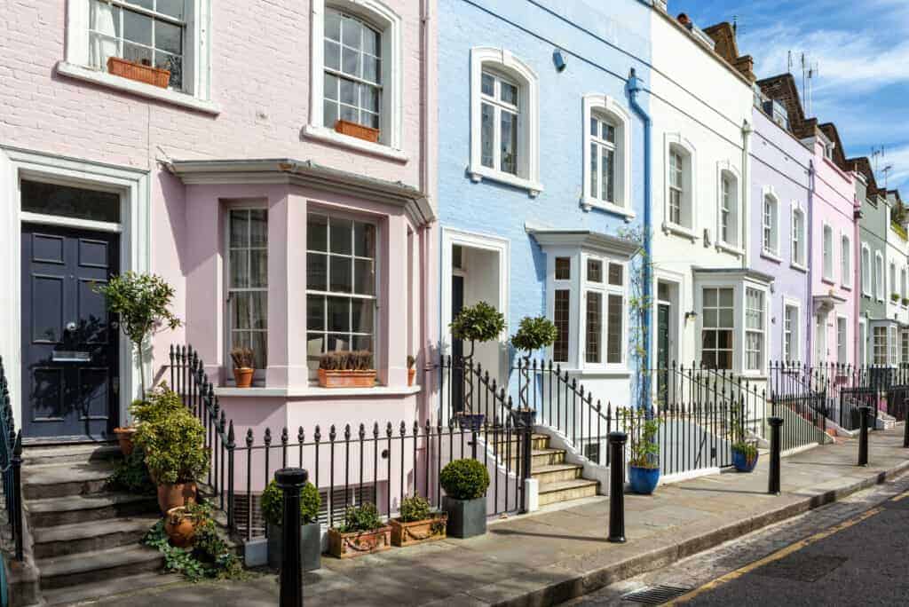 pastel colored houses line a street in Chelsea London
