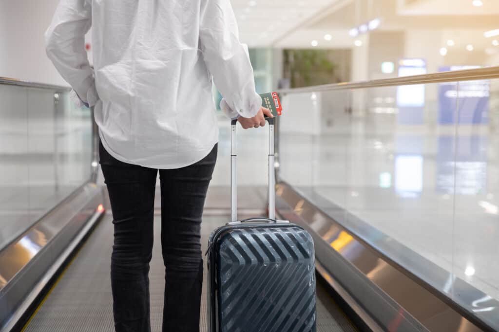 woman with suitcase at an airport