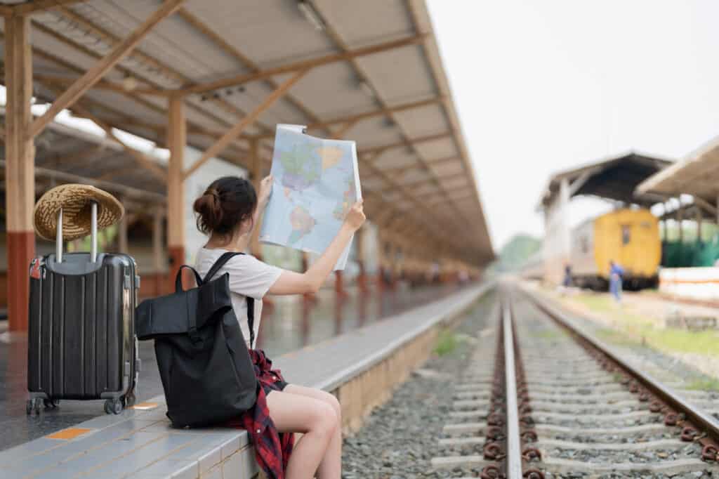 woman at a train station looking at a map