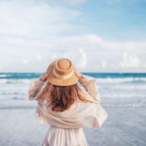 woman in a dress relaxing at the beach