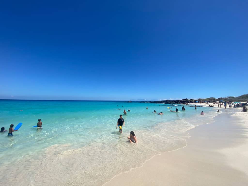 clear calm bright blue water on a white sand beach