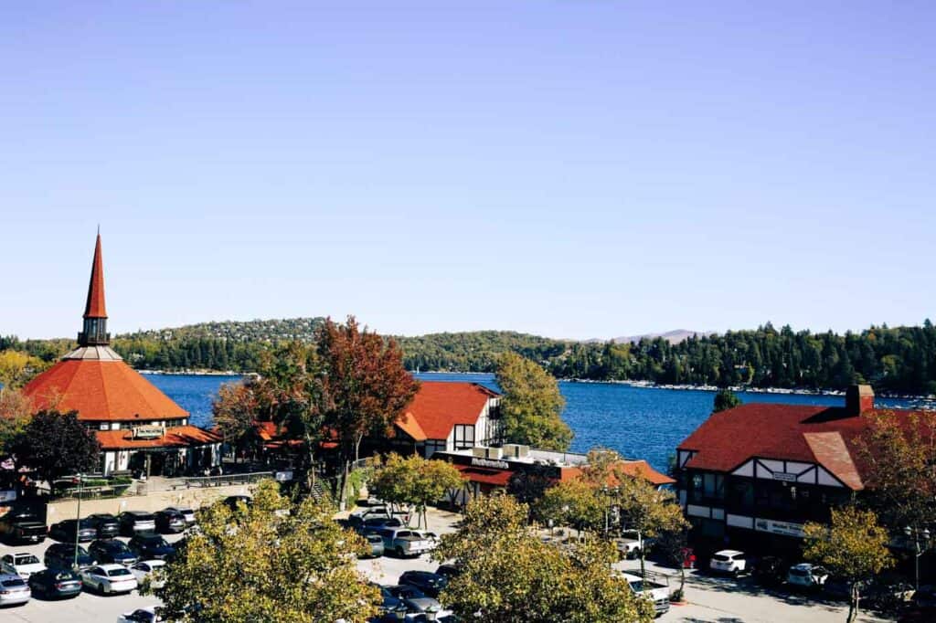 Alpine-style buildings with red roofs sit on the shores of Lake Arrowhead