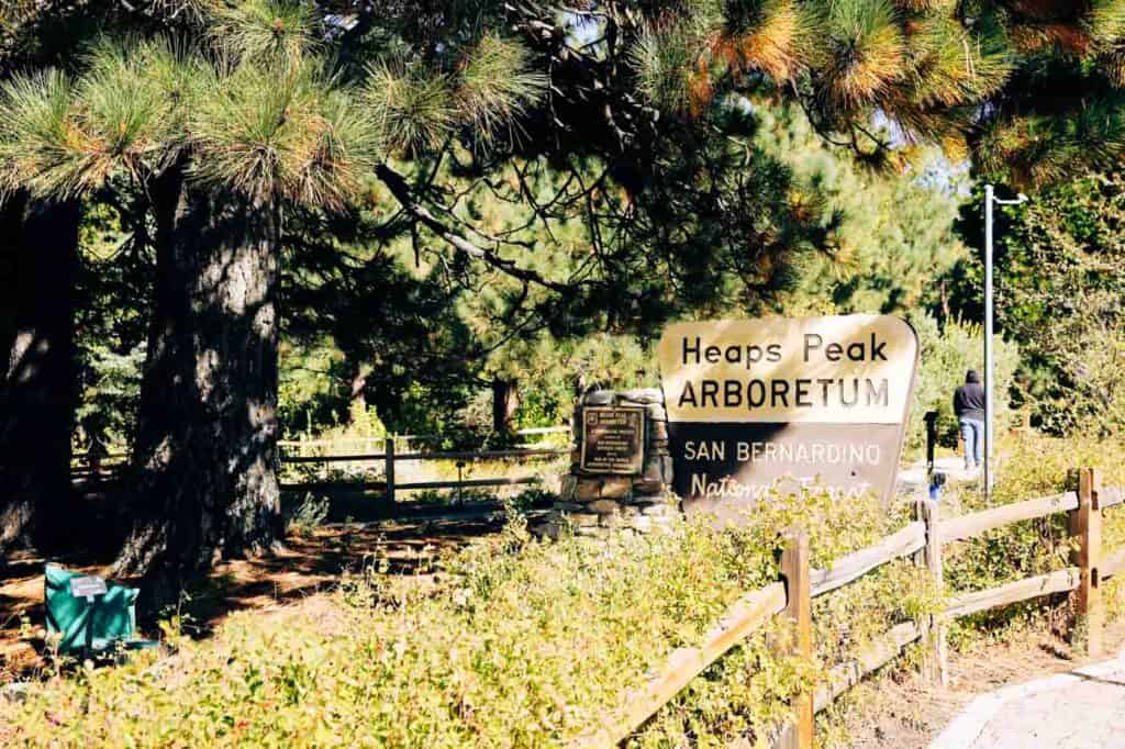 A wooden sign welcomes visitors to Heaps Peak Arboretum