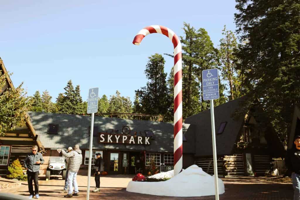a giant candy cane sculpture outside of the entrance to skypark