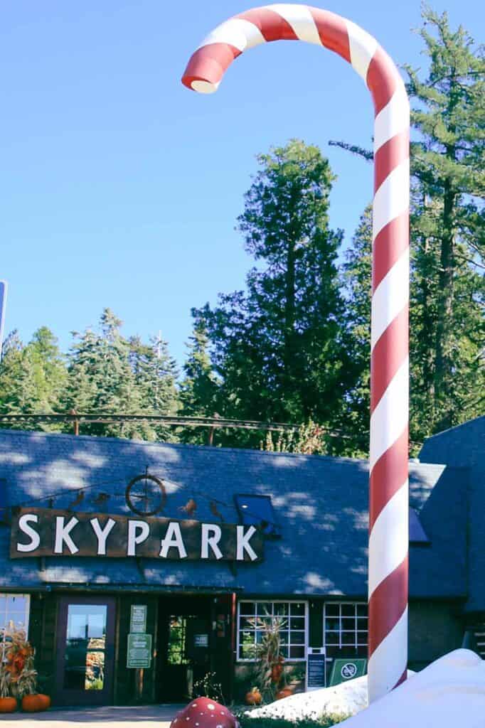 Sculpture of a giant candy cane outside of the entrance to Santa's Village