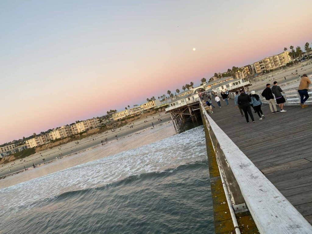 view from crystal pier in San Diego at sunset with a full moon