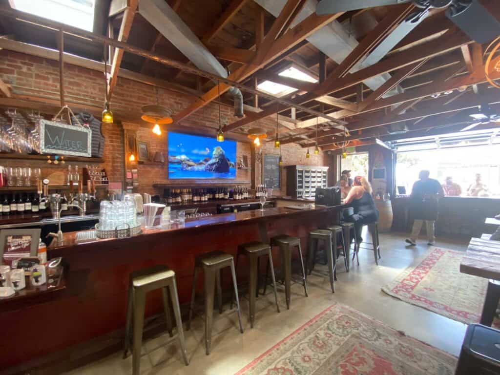 stools at a wooden bar in the tasting room at comber craft wines