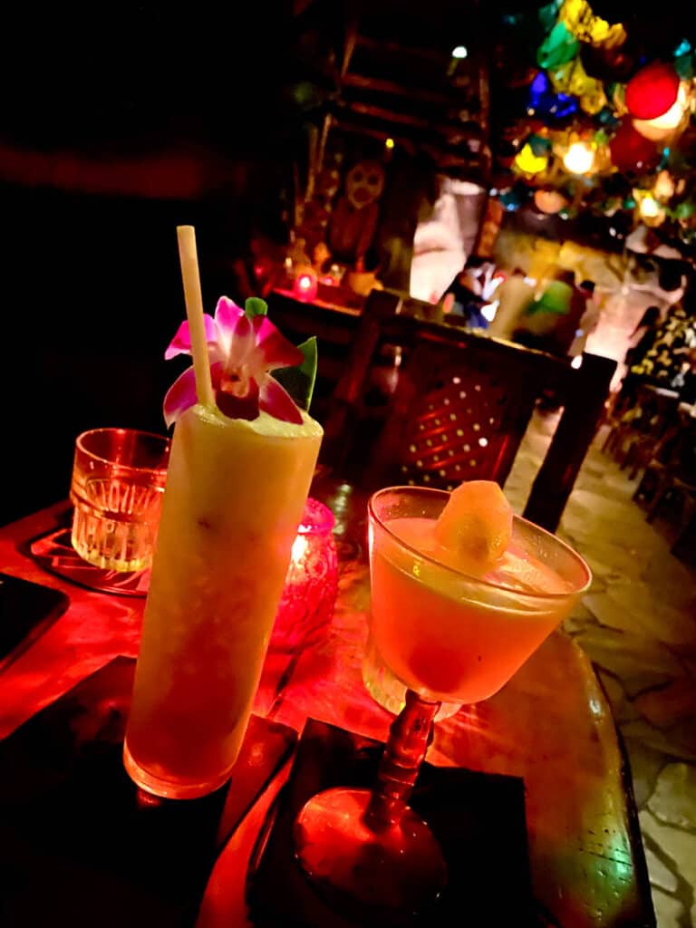 tropical cocktails inside a tiki themed speakeasy bar