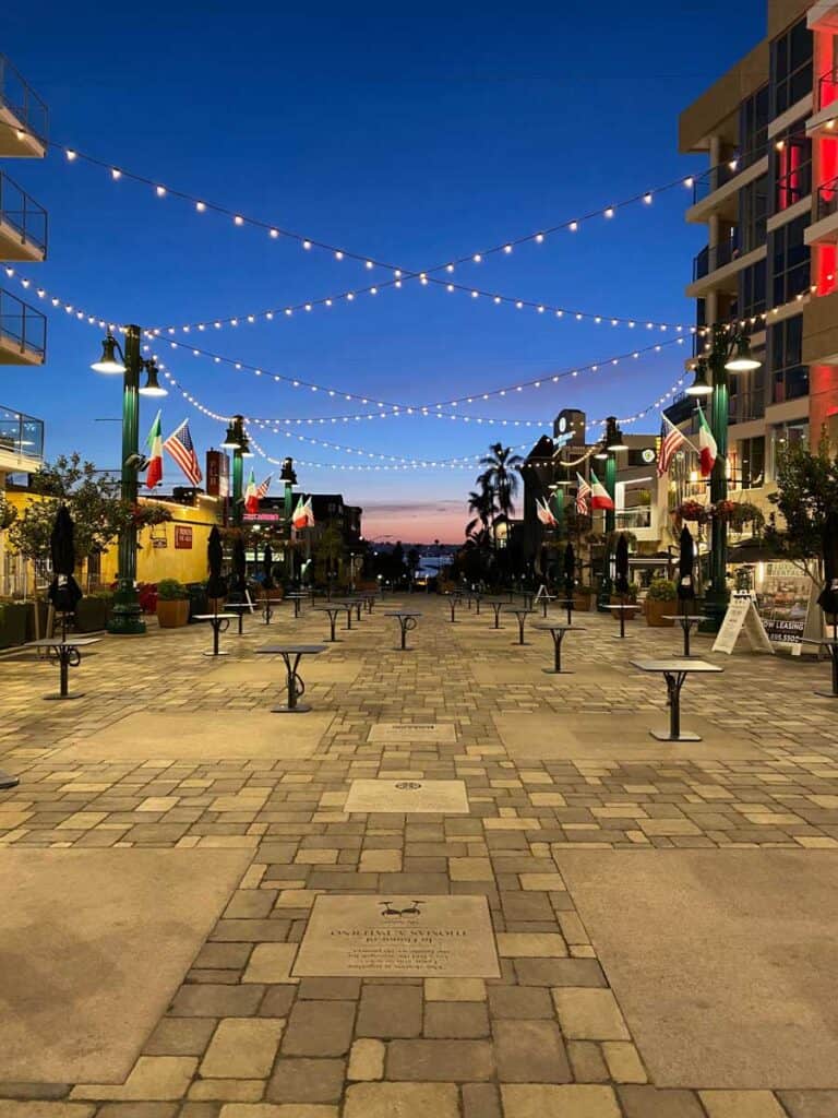 string lights illuminate the piazza della famiglia in san diego's Little Italy neighborhood