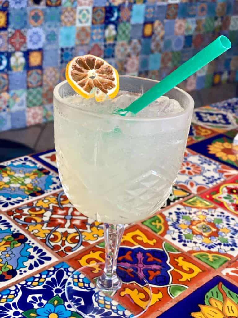 margarita on ice sits atop colorful Mexican tile