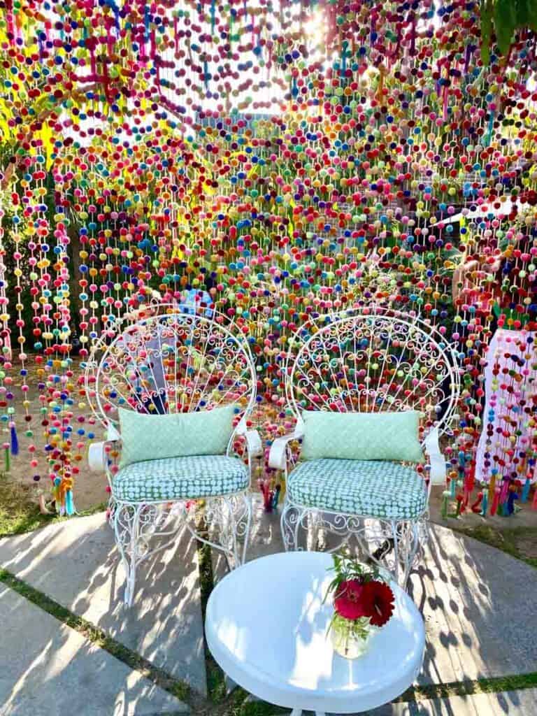 whimsical lounge chairs in front of colorful beads at Flora Farms