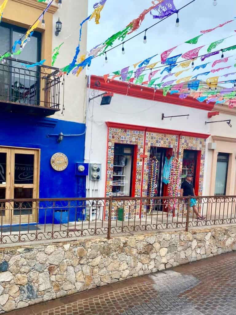 colorful buildings and flags line cobblestone streets of San Jose del cabo