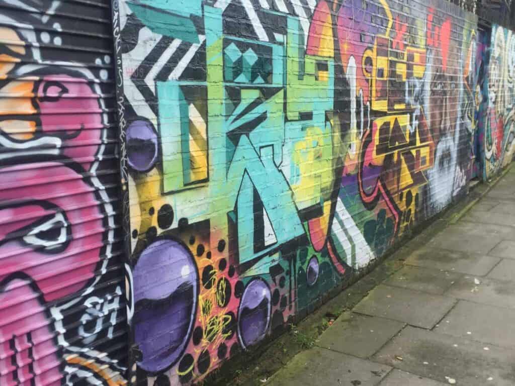 colorful neon graffiti on a back alleyway in London