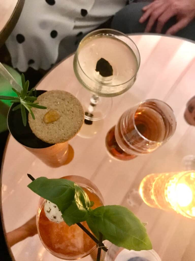 Four decorated cocktails sit on a table