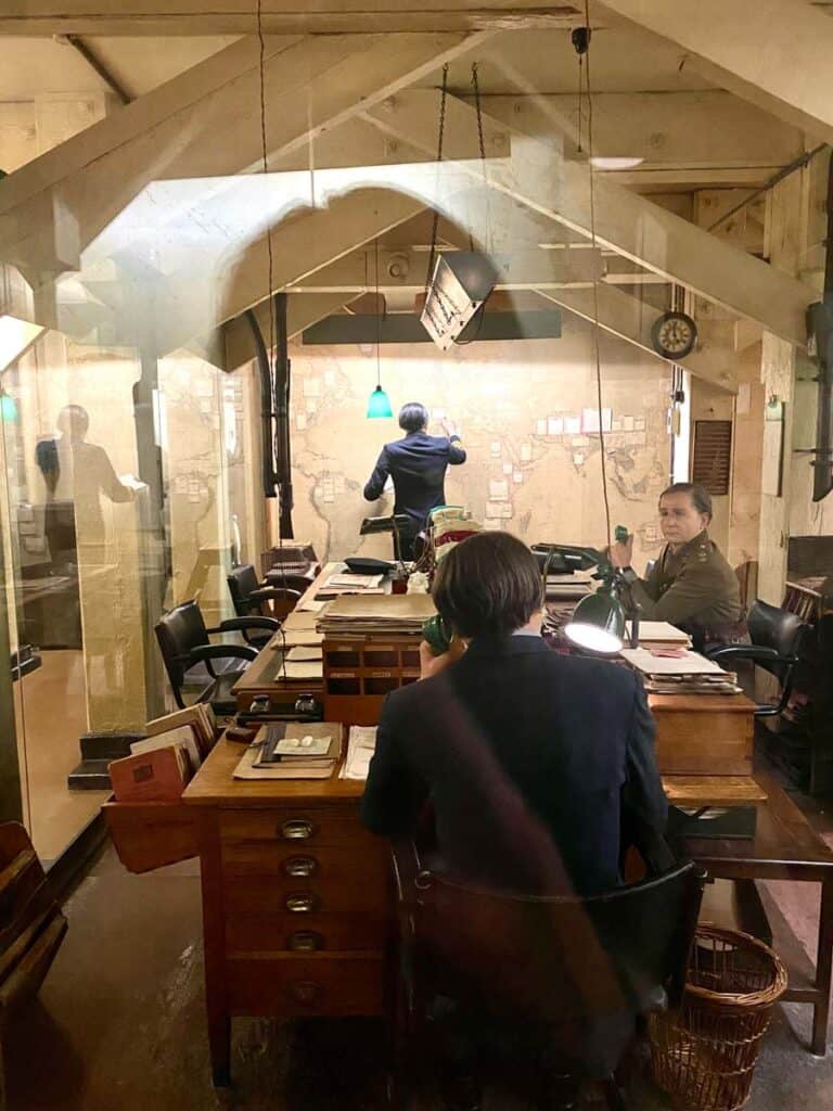 A life size replica of men around a conference room table