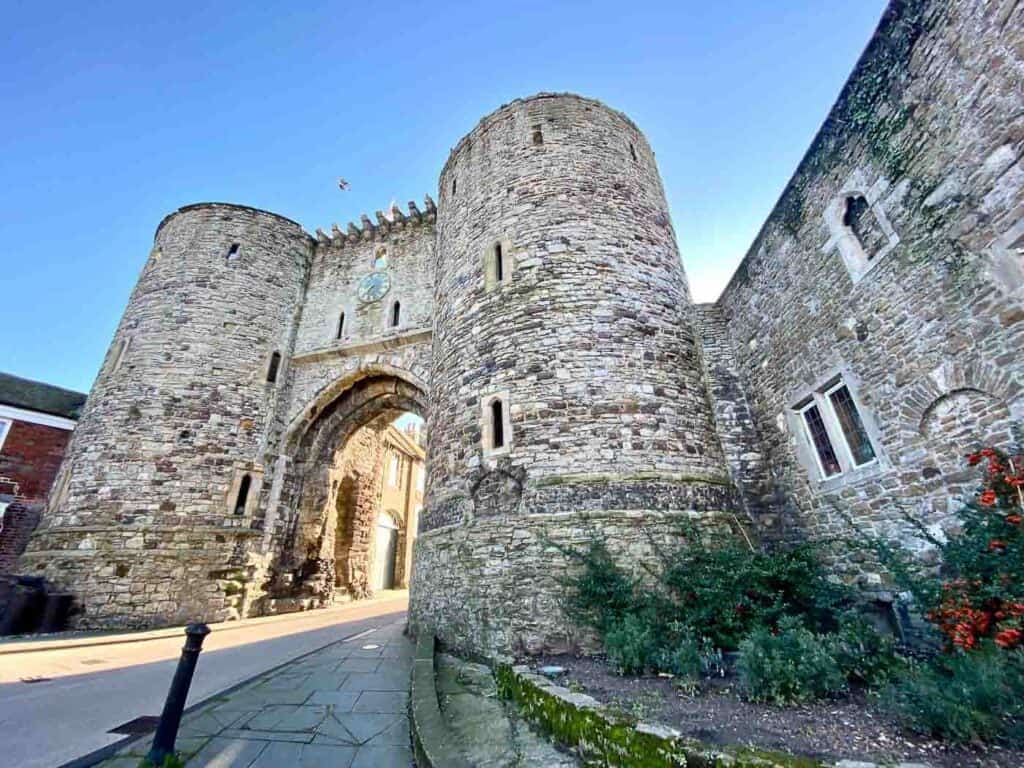 a medieval gate made of stone serves as an entryway to the town of Rye England