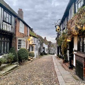 tudor style buildings line a cobblestone street in rye sussex