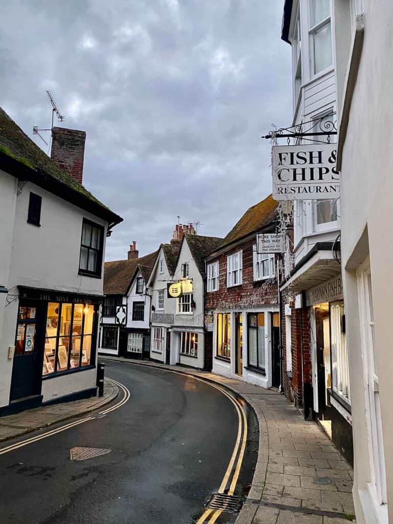 medieval buildings line a curved street at dusk in rye sussex