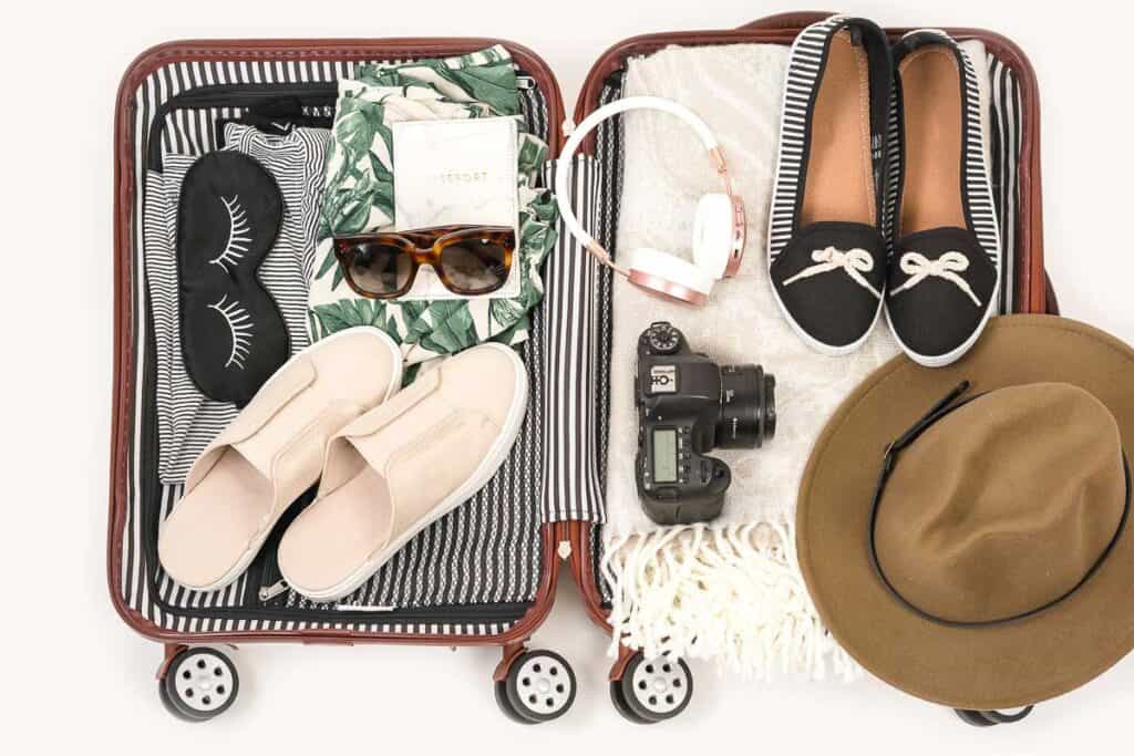 an open suitcase is packed with travel outfits