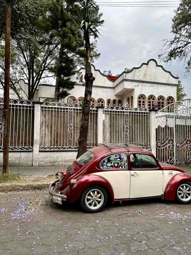 vintage vw beetle car parked outside of an old building in Mexico