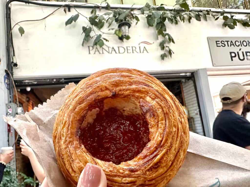 round pastry with fruit filling in front of a panadería in Mexico City