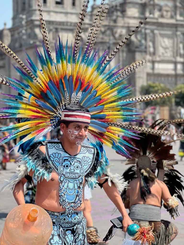 man with a colorful headdress dancing in Mexico City's Zócalo